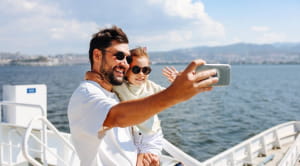 Father and son take selfie on cruise ship
